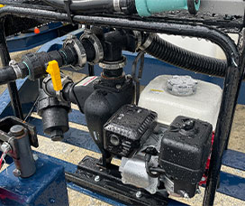 Close up picture of a water trailer pump and engine