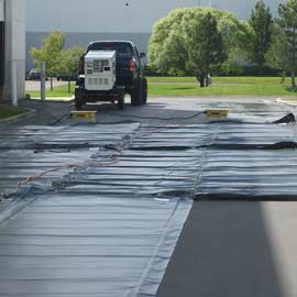 Concrete curing blankets deployed on the ground