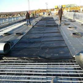 Concrete curing blankets deployed on a job site