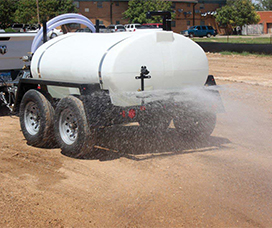 500 gallon arena sprayer trailer spraying off the back