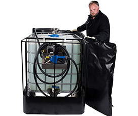Man wrapping a power heater blanket around an IBC tote