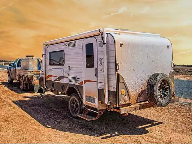 a man taking a photo of his family next to a RV