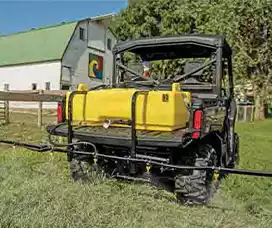 UTV-mounted yellow sprayer with boom attachment, designed for precise and efficient spraying applications.