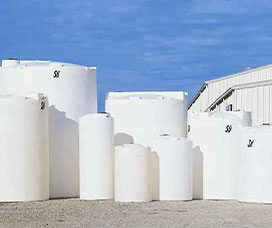 Multiple plastic storage tanks in front of the water